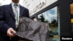 Sebuuah tas merek LVMH palsu dipajang di depan toko Louis Vuitton di Chevy Chase, Maryland, AS.