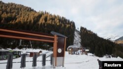 A man walks next to a closed chairlift at Les Portes du Soleil ski resort during the global outbreak of the coronavirus disease (COVID-19), in Chatel, France, Dec. 19, 2020. 