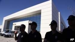FILE - Turkish police outside Koza Ipek Holding during a raid in September 2015.