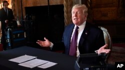 President Donald Trump speaks to reporters following his teleconference with troops from his Mar-a-Lago estate in Palm Beach, Fla., Nov. 22, 2018.