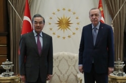 Turkey's President Recep Tayyip Erdogan, right, and Chinese Foreign Minister Wang Yi pose for a photo before a meeting, in Ankara, Turkey, March 25, 2021.