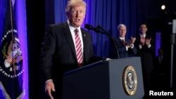 U.S. President Donald Trump is applauded by Vice President Mike Pence and House Speaker Paul Ryan as he arrives to speak at a congressional Republican retreat in Philadelphia, Jan. 26, 2017.