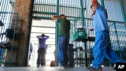 FILE - Suspected illegal immigrants are being processed at the Tucson Sector of the U.S. Customs and Border Protection headquarters in Tucson, Ariz., Aug. 9, 2012.
