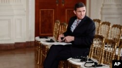 FILE - National Security Adviser Michael Flynn sits in the front row before the start of the President Donald Trump and Japanese Prime Minister Shinzo Abe joint new conference in the East Room of the White House, in Washington, Friday, Feb. 10, 2017. (AP Photo/Carolyn Kaster)