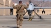 A U.S. airman guides a U.S. Air Force MQ-9 Reaper drone as it taxis to the runway at Kandahar Airfield, Afghanistan, March 9, 2016. 