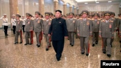 North Korean leader Kim Jong Un (C) visits the Kumsusan Palace of the Sun at midnight on Tuesday on the occasion of the 20th anniversary of the demise of President Kim Il Sung in this photo released by North Korea's Korean Central News Agency (KCNA) in Py