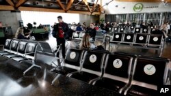 FILE - Passengers wait to board their flight at Christchurch Airport in Christchurch, New Zealand, May 14, 2020. 