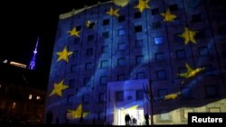FILE - The European flag is projected on the government building as the TV tower is illuminated in blue in the background in Tbilisi, Georgia, December 18, 2015.