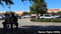 In north Houston, a group of mostly undocumented, Latino men wait outside a Home Depot, in search of manual cleanup work.