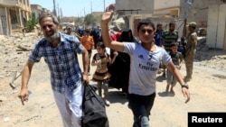 Displaced Iraqi people who fled homes during a fight between Iraqi forces and Islamic State militants are photographed in al-Zanjili neighborhood, north of the Old City district of Mosul, Iraq, May 30, 2017. 