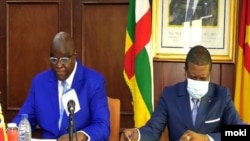 C.A.R. minister of Transport and Civil Aviation, Arnaud Djoubaye- and Cameroon’s transport minister, Jean Ernest Messina Ngale Bibehe, Yaounde, Feb. 24, 2021. (Moki Edwin Kindzeka/VOA)