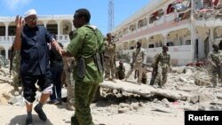 Security forces assist Abdalla Boss, a Somali parliamentarian wounded in a car bombing near the president's palace in Mogadishu, Aug. 30, 2016. Al-Shabab asserted responsibility. The U.S. military says it conducted airstrikes Monday against al-Shabab militants. 