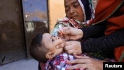 FILE - A boy receives polio vaccine drops during an anti-polio campaign in Peshawar, Pakistan, Feb. 17, 2020. 