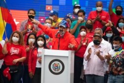 FILE - Venezuela's President Nicolas Maduro speaks to supporters during a closing campaign rally for National Assembly elections in Caracas, Venezuela, Dec. 3, 2020.