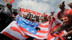 Philippines US: Filipino tribal groups and activists shout slogans as they burn a mock U.S. flag near the Malacanang presidential palace in Manila, Philippines, Friday, Oct. 21, 2016. 