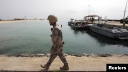 FILE - A Saudi border guard patrols Saudi Arabia's maritime border with Yemen along a beach on the Red Sea, near Jizan, Apr. 8, 2015.