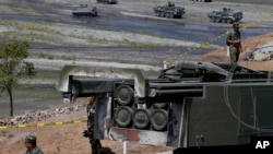 A U.S.-made HIMARS (High Mobility Advanced Rocket System) is displayed amidst armored personnel carriers after taking part in the 11-day joint U.S.-Philippines military exercise dubbed "Balikatan 2016," April 14, 2016 at Crow Valley, north of Manila, Philippines. 