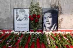 Flowers are left at a makeshift memorial in Yangon, for the people killed during a protest against the military coup in Mandalay on the previous day, Myanmar, Feb. 21, 2021.
