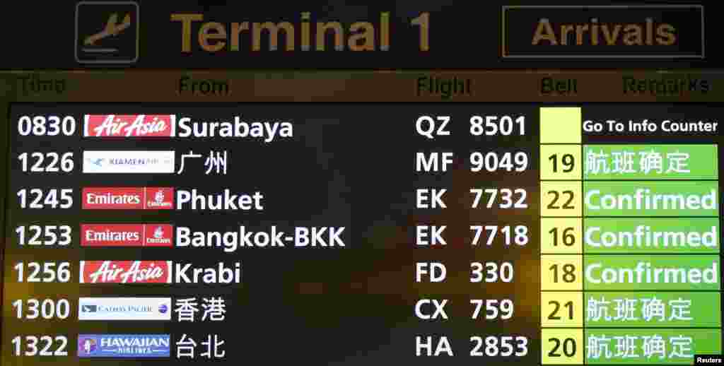 A flight information signboard shows the status of AirAsia flight QZ 8501 from the Indonesian city of Surabaya to Singapore at Changi Airport in Singapore, Dec. 28, 2014.