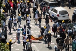 Demonstrators gather on a road during an anti-coup protest in Yangon, Myanmar, March 4, 2021.