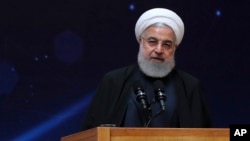 In this photo released by the official website of the office of the Iranian Presidency, President Hassan Rouhani speaks during a ceremony commemorating "National Day of Nuclear Technology," in Tehran, Iran, April 9, 2019.