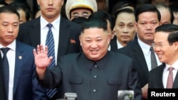 North Korea's leader Kim Jong Un waves as he arrives at the Dong Dang railway station, Vietnam, at the border with China, Feb. 26, 2019. 