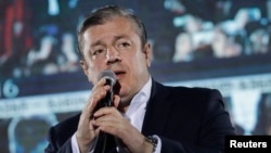 FILE - Georgian Prime Minister Giorgi Kvirikashvili addresses to supporters during a rally in Tbilisi, Georgia, Oct. 8, 2016.