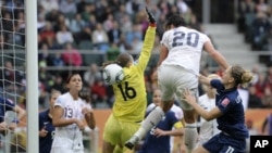 United States' Abby Wambach, center, scores her side's 2nd goal during the semifinal match between France and the United States at the Women�s Soccer World Cup in Moenchengladbach, Germany, July 13, 2011