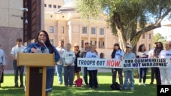 FILE - Amy Juan, a resident of the Tohono O'odham Nation in Arizona, speaks out against the military's presence at the U.S.-Mexico border in Phoeni, Nov. 8, 2018.
