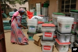 FILE - An election worker checks ballot boxes at the electoral commission office in Yola, Nigeria, Feb. 24, 2019. A surge of violence targeting Nigeria's election commission offices and extremist attacks in remote communities are already raising concerns about the upcoming February elections in Africa's most populous nation.