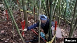FILE - A member of the Humanitarian Demining Battalion of the Columbian Army searches for landmines in Cocorna, Antioquia, March 3, 2015.
