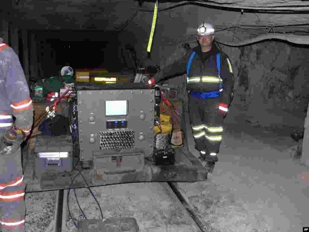 An undated photo provided by Lockheed Martin shows Lockheed engineer Dave LeVan standing next to a MagneLink underground mining communication system. LeVan developed the technology that uses magnetic waves to send signals to the surface in the event of a mining disaster. (AP)
