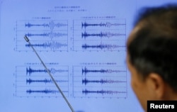 Japan Meteorological Agency's earthquake and tsunami observations division director Toshiyuki Matsumori points at graphs of ground motion waveform data observed in Japan during a news conference at the Japan Meteorological Agency in Tokyo, Japan, Sept. 3, 2017.