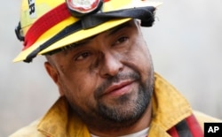 Firefighter Mark Tabaez speaks with a reporter after battling a wildfire in Clayton, Georgia, Nov. 15, 2016.