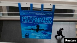 FILE - A delegate walks past a banner during a break at the International Civil Aviation Organization's (ICAO) global safety meeting in Montreal, Feb. 4, 2015. Taiwan has not been invited to attend the upcoming event Sept. 27, following pressure from China.