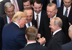 FILE - U.S. President Donald Trump, left, shakes hands with Russian President Vladimir Putin, right, as Turkey's President Recep Tayyip Erdogan, 2nd right, and U.N. Secretary-General Antonio Guterres, left, look on, in Osaka, Japan, June 29, 2019.
