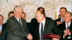 FILE - Russian President Boris Yeltsin and Belarus leader Stanislav Shushkevich, exchange Slovic Treaty in Brest, USSR (Russian Federation) Dec. 7, 1991.