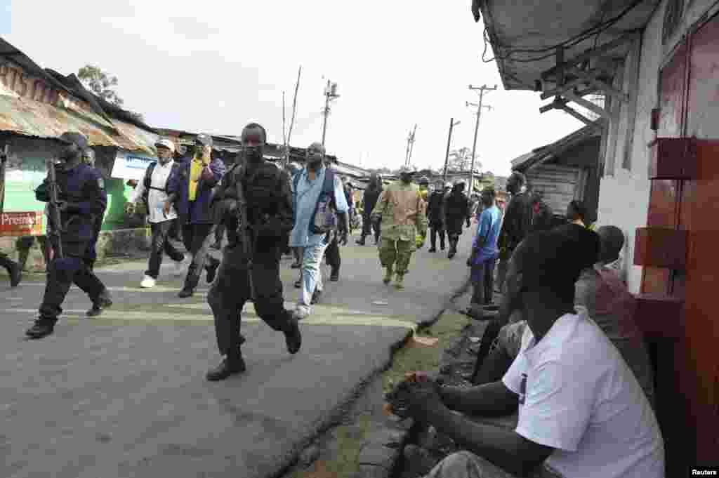 Liberian security forces patrol a street after clashes at West Point neighborhood in Monrovia, Aug. 20, 2014.