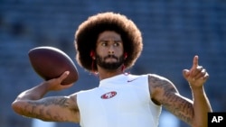 San Francisco 49ers quarterback Colin Kaepernick warms up for a preseason football game against the San Diego Chargers, in San Diego, Calif., Sept. 1, 2016. He's been criticized for refusing to stand for the national anthem. 