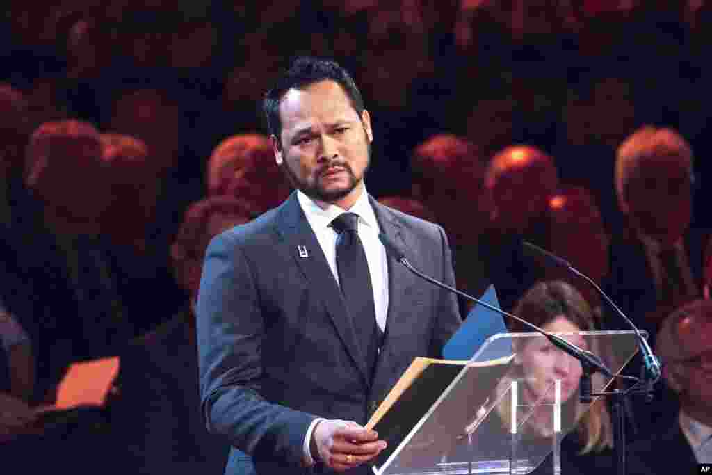 Paul Marckelbach, who lost his mother, sister, brother-in-law and nephews, reads a poem for grieving family members and friends of victims of the Malaysia Airlines Flight 17 disaster who gathered for a national commemoration ceremony in Amsterdam, Nov. 10, 2014. 