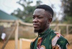 FILE - Motorcycle taxi driver Germain Kalubenge is photographed at an Ebola transit center where potential cases are evaluated, in Beni, Congo, Aug. 22, 2019.