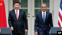 FILE - President Barack Obama and Chinese President Xi Jinping arrive for their joint new conference, Sept 25, 2015.