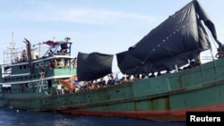 A Kashmiri man removes snow from a hotel premise in Gulmarg, about 55 kilometers (34 miles) northwest of Srinagar, Indian-controlled Kashmir. Authorities have issued avalanche warnings for many parts of the region, as the heavy snowfall has cut off roads, disrupted power and communication lines, and forced the evacuation of hundreds of residents.