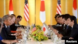 U.S. President Barack Obama speaks to Japanese Prime Minister Shinzo Abe (R) during their meeting at the Akasaka Palace in Tokyo, April 24, 2014.