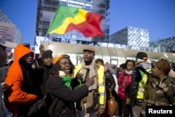 Supporters of Former Ivory Coast President Laurent Gbagbo and former Minister Charles Ble Goude rally outside the International Criminal Court in The Hague, Netherlands, Jan. 28, 2016.
