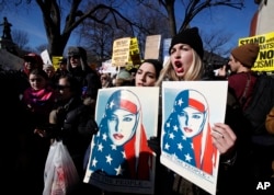 Demonstrators chants during a rally protesting the immigration policies of President Donald Trump, near the White House in Washington, Feb. 4, 2017.