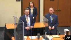 In this image taken from video, defense attorney Eric Nelson, L, defendant former Minneapolis police officer Derek Chauvin, R, are seen during jury selection at the Hennepin County Courthouse in Minneapolis, March 22, 2021. 