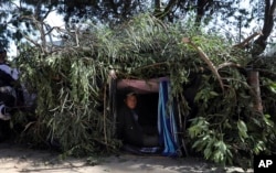 Honduran migrant Mauro Hernandez rests inside a makeshift tent at a temporary shelter in Tijuana, Mexico, Nov. 17, 2018.