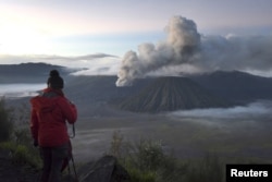 FILE - A visitor takes photographs of Mount Bromo, an active volcano and popular tourist destination, in Probolinggo, East Java province, Indonesia, April 3, 2016 in this photo taken by Antara Foto.