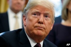 FILE - President Donald Trump listens to a question during a signing ceremony at the White House.